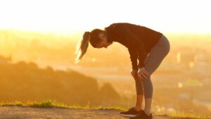 Tired Runner 1920×1080 Exhausted female runner with hands on knees