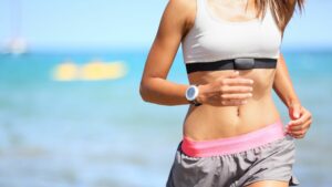 Close up of torso woman running with a heart rate monitor