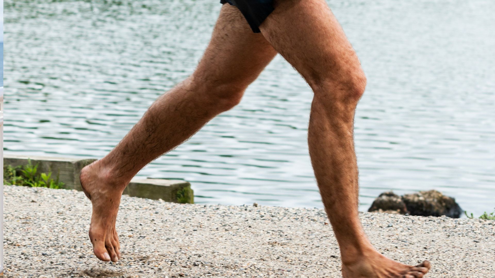 Close up of legs of man running barefoot